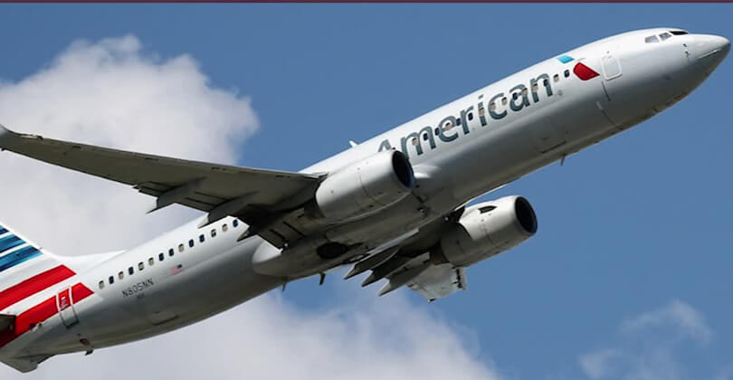 Picture of an American Airlines airplane bringing patients to Frontline Plastic Surgery in San Jose, Costa Rica.  The airplane is ascending and shows American Airlines new colors.